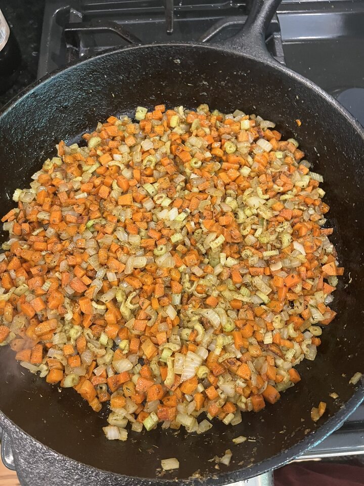 Cooked onion, celery, and carrot in a skillet for meatloaf filling