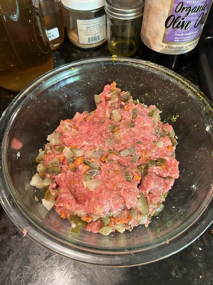 Ground meat gently mixed with cooked vegetables for classic meatloaf